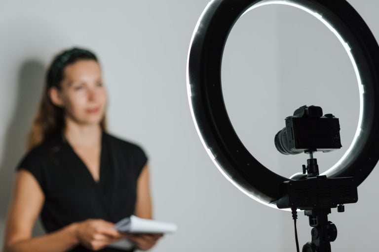 A woman filming a video about how video sharing helps in getting backlinks.