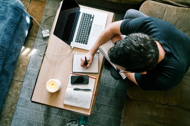 A man taking notes on effective social media video strategies for growing your brand.